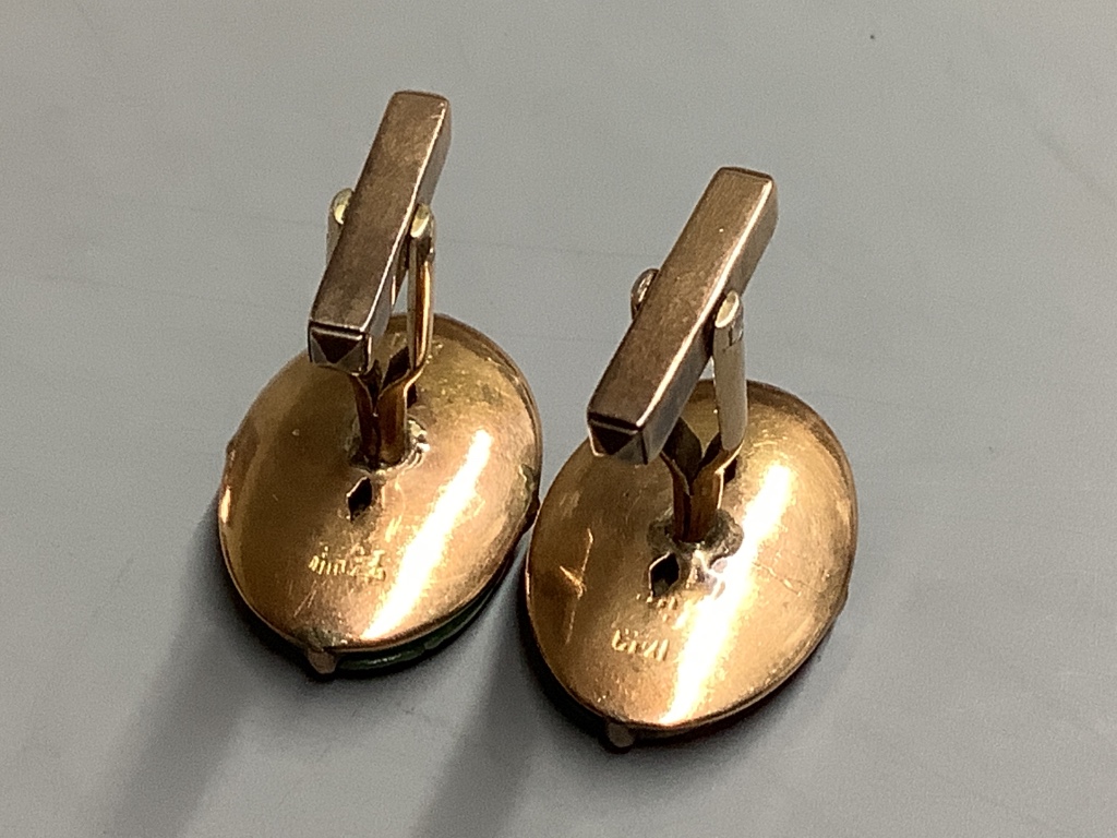 A pair of Chinese 14K gold and green jade oval cufflinks